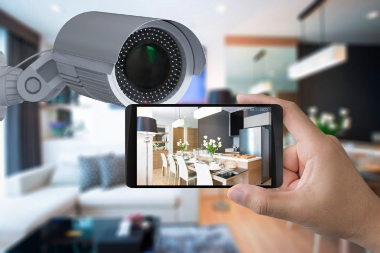 hand holding mobile connect with security camera